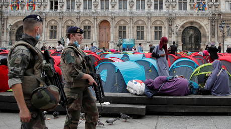 Residents of homeless migrant camp outside Paris City Hall given temporary shelter after protest